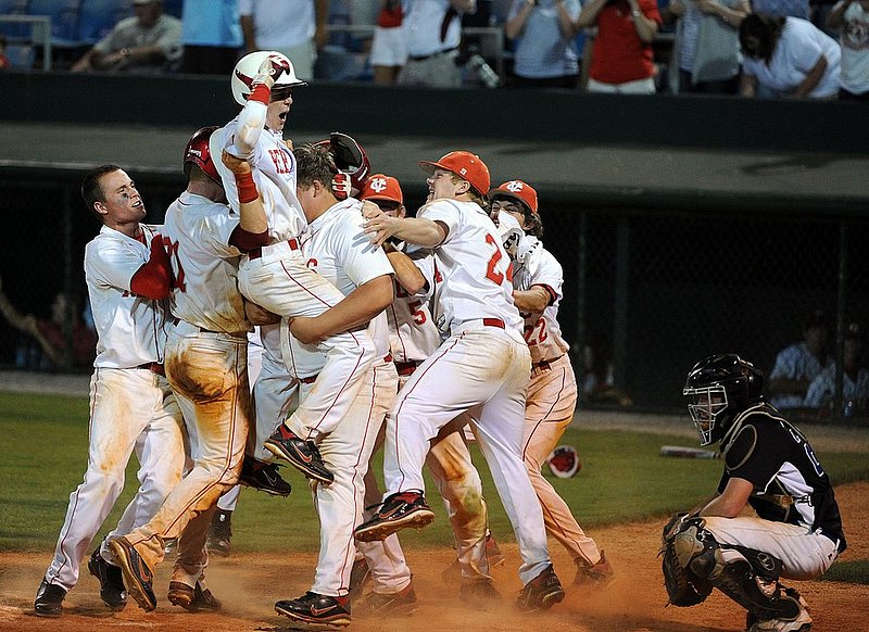 051110  AISA CLASS A STATE CHAMPIONSHIP_003.jpg :: Crenshaw Christain catcher Tate Welch (24) watches as Coosa Valley Steven Cryer (1) is lifted in the air by team mates as they celebrate their 5-4 win in the Class A AISA state championship game Tuesday May 10, 2011 at Patterson Field in Montgomery, Ala. Crenshaw Christian pitcher Jud Sutlcy was called for a balk in the bottom of the seventh inning  with bases loaded forcing the winning run in. (The Birmingham News, Hal Yeager)