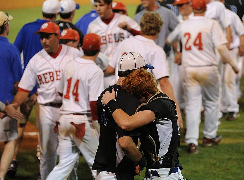 051110  AISA CLASS A STATE CHAMPIONSHIP.jpg :: Crenshaw Christian's Rann Smyth (14) and Tate Welch (24) embrace after their loss to Coosa Valley in the Class A AISA state championship game Tuesday May 10, 2011 at Patterson Field in Montgomery, Ala. (The Birmingham News, Hal Yeager)