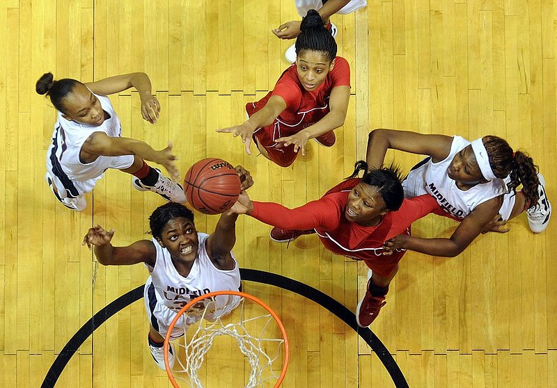 22512  MIDFIELD SUMTER CENTRAL_004.jpg :: Midfield's LaToya Wilson (34) tries to stop Sumter Central's Brittany Bonner (32) as she tips the ball in in an AHSAA Central Regional girls 4A final basketball game at the Dunn-Oliver Acadome, Saturday Feb. 25, 2012 in Montgomery, Ala. Also shown are Midfield's Courtney Baldwin (10), Midfield's Dionnika Moore (21) and Sumter Central's Haven Moore (00). (The Birmingham News, Hal Yeager)