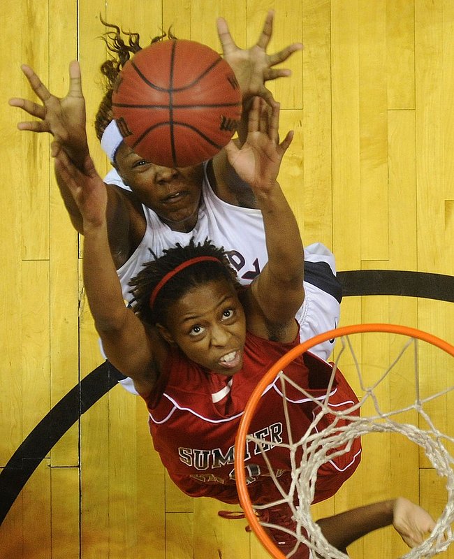 22512  MIDFIELD SUMTER CENTRAL.jpg :: Sumter Central's Shaquala Bryant (10) and Midfield's Dionnika Moore (21) battle for a rebound in an AHSAA Central Regional girls 4A final basketball game at the Dunn-Oliver Acadome, Saturday Feb. 25, 2012 in Montgomery, Ala. (The Birmingham News, Hal Yeager)