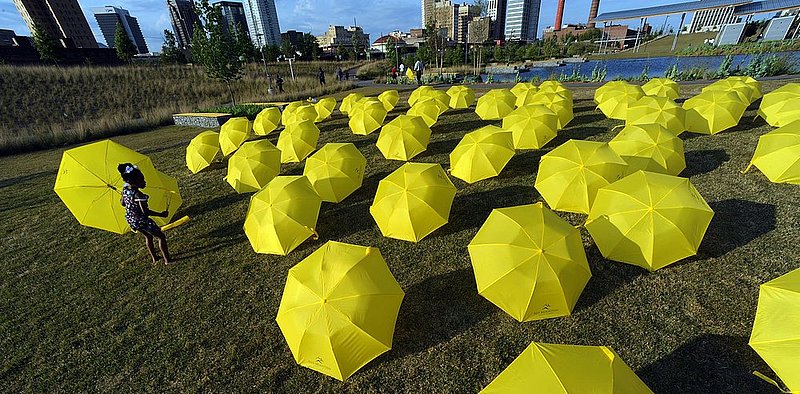 42512 UMBRELLAS_001.jpg :: Emily Smith, 4, picks out one of 70 umbrellas that were placed in Railroad Park Thursday April 26, 2012 in Birmingham, Ala., as a promotion for Red Mountain Theatre's next show \