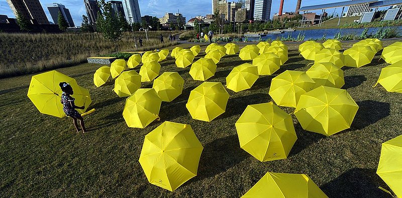 42512 UMBRELLAS_0011.jpg :: Emily Smith, 4, picks out one of 70 umbrellas that were placed in Railroad Park Thursday April 26, 2012 in Birmingham, Ala., as a promotion for Red Mountain Theatre's next show \