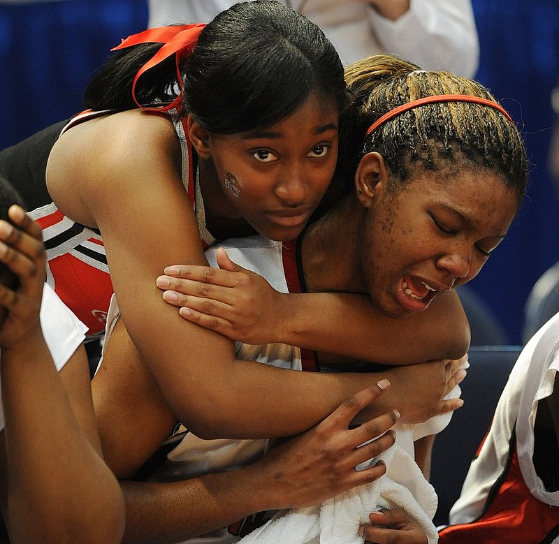5A GIRLS TALLADEGA EUFAULA_001.jpg :: Talladega cheerleader Gabrielle McKinney comforts a crying Jessica Merritt in the girls class 5A state basketball championship final Friday, February 29, 2008. Eufaula wins 64-53. News staff/Hal Yeager reporter/Victory