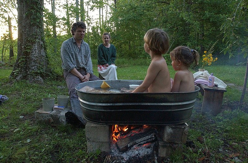 AL-CHY56-0171.jpg :: Weekends with mom Helene at her boyfriend Tres Taylor's woodsy cabin is the kids' favorite time of the week. Here, Everett and Stella Knowlton take a bath the old-fashioned way: in a galvanized steel tub heated by a dying campfire.