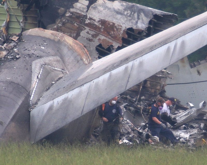 ALHY  105.jpg :: NTSB investigators remove the flight data recorder or \