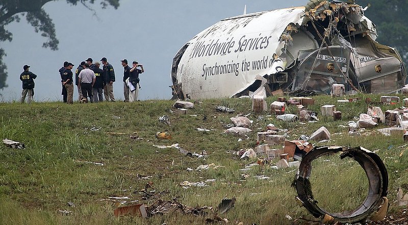 ALHY 112 .jpg :: NTSB investigators look over the debris of a UPS A300 cargo plane after it crashed on approach at Birmingham-Shuttlesworth International Airport  this morning Wednesday August 14,  2013 in Birmingham, Ala. (AP Photo/Hal Yeager)