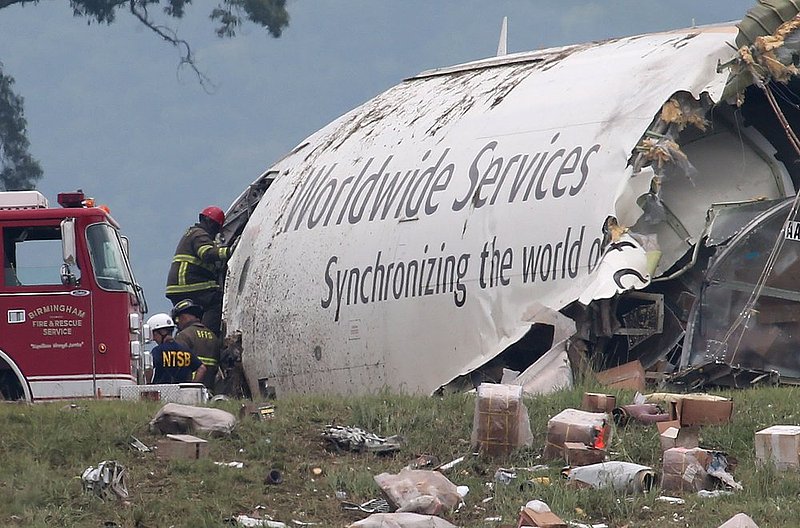 ALHY 115.jpg :: A Birmingham firefighter enters the fuselage of a UPS A300 cargo plane after it crashed on approach at Birmingham-Shuttlesworth International Airport  this morning Wednesday August 14,  2013 in Birmingham, Ala. (AP Photo/Hal Yeager)