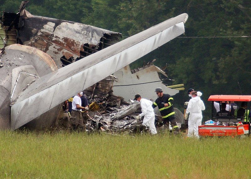 ALHY103.jpg :: NTSB investigators work around the tail section of the UPS cargo plane that crashed on approach to the Birmingham-Shuttlesworth International Airport August 15,  2013 in Birmingham, Ala. (Photo/Hal Yeager)
