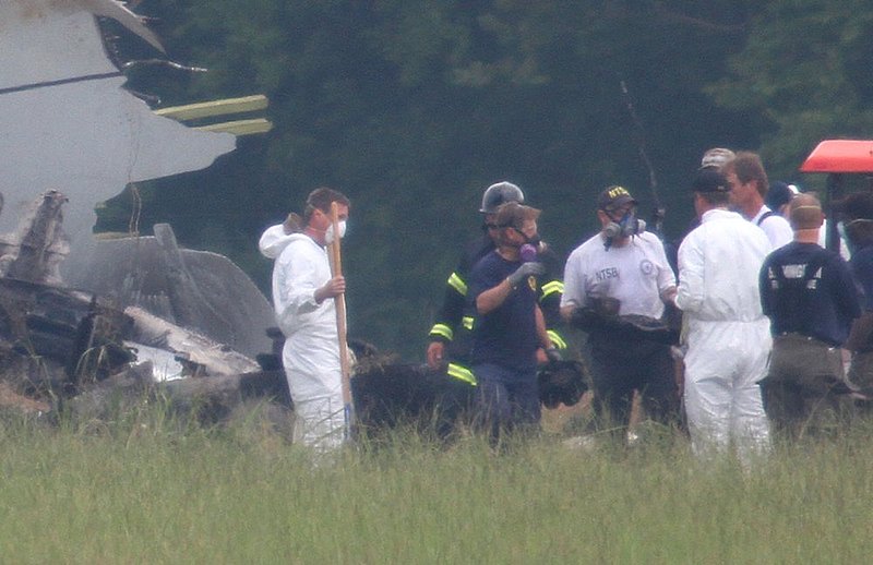ALHY106.jpg :: NTSB investigators remove the flight data recorder or \