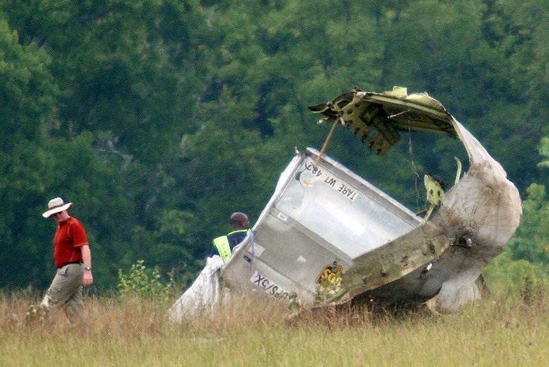 ALHY108 .jpg :: An unidentified person looks at a cargo carrier from the UPS cargo plane that crashed on approach to the Birmingham-Shuttlesworth International Airport August 15,  2013 in Birmingham, Ala. (Photo/Hal Yeager)