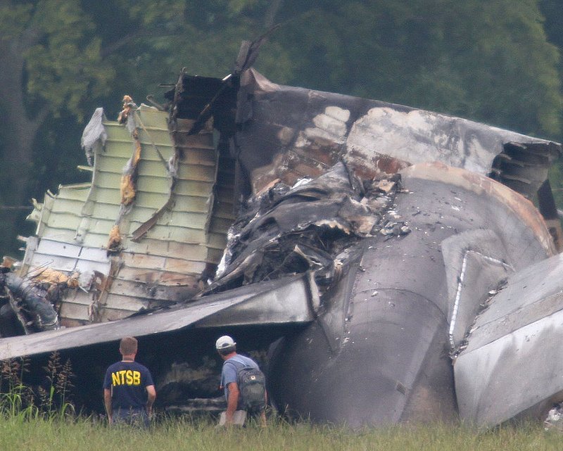ALHY109.jpg :: An NTSB investigator and an unidentified person look over the tail section of the UPS cargo plane that crashed on approach to the Birmingham-Shuttlesworth International Airport August 15,  2013 in Birmingham, Ala. (Photo/Hal Yeager)