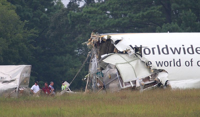 ALHY110.jpg :: Investigators work the scene of the UPS cargo plane that crashed on approach to the Birmingham-Shuttlesworth International Airport August 15,  2013 in Birmingham, Ala. (Photo/Hal Yeager)