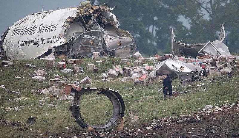 ALHY1101.jpg :: Investigators look through  debris of a UPS A300 cargo plane after it crashed on approach at Birmingham-Shuttlesworth International Airport  this morning Wednesday August 14,  2013 in Birmingham, Ala. (Photo/Hal Yeager)
