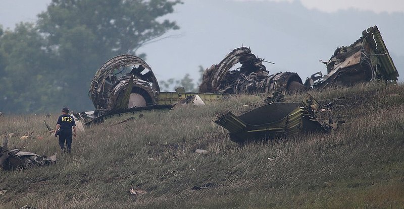 ALHY111 .jpg :: An NTSB investigator looks over the debris of a UPS A300 cargo plane after it crashed on approach at Birmingham-Shuttlesworth International Airport  this morning Wednesday August 14,  2013 in Birmingham, Ala. (AP Photo/Hal Yeager)