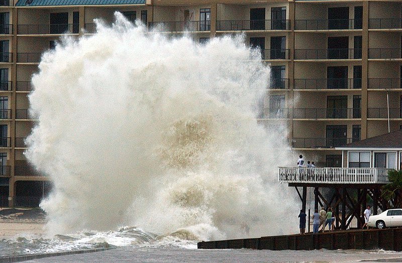 ARLENE_001.jpg :: ARLENE--Tropical storm Arlene made land fall around 2pm this afternoon in the Orange Beach area with gusty winds, some heavy rain and a pounding surf. Rob Newton, of Birmingham, and kids Chase and Sydney stand on the deck of Rob's house The Point House, at Alabama Point, and watch as a large wave crashes against a sea wall. News staff/Hal Yeager reporter/Osborne