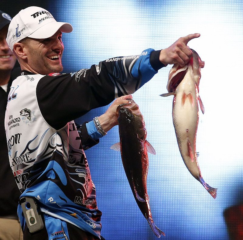 Bassmaster Classic ALHY104.jpg :: Randy Howell, Springville, Ala., points to family and supporters as he holds up two bass at the weigh-in,  Sunday Feb. 23, 2014 in Birmingham, Ala. that helped him to win the Bassmaster Classic. on Lake Guntersville. (Photo/Hal Yeager)