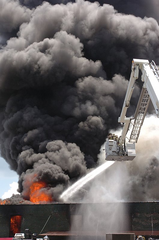 FIRE.jpg :: A warehouse with more than one million pairs of shoes inside goes up in flames in downtown Birmingham, Ala., Thursday, June 8, 2006. The warehouse is owned by Shoe Corp. and supplies shoes and sandals to prisons. 
