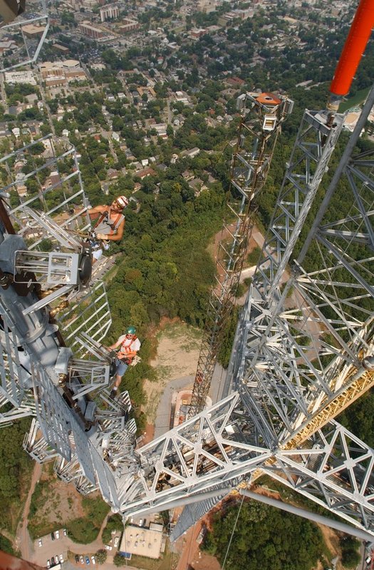 TOWER WORK  2231.jpg :: Construction workers for Carolina Towers put the finishing touches on a 1,oooft tower on top of Red Mountain. While Daryl Matthews, Lake Charles, La., operates a crane atop the structure, right,  workers Clayton Black, Yacima Wash., top left and Jessie Smith, Port Author Tx., lower left work on one of the FM towers atop the star mount. Soone the crane atop the structure will be removed after  the  year long construction.
News staff/Hal Yeager  reporter/
