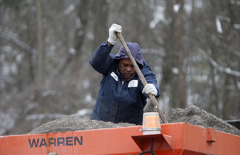 WINTER WEATHER ALHY103 9.53.42 PM.jpg :: Fort Payne Public Works Carl Prater use s a shovel to shift sand in the bed of his sand truck as they sand area roads Wednesday Feb. 12,  2014 in Fort Payne Ala. . Officials are warning of ice and snow accumulations as the day continues. (AP Photo/Hal Yeager)
