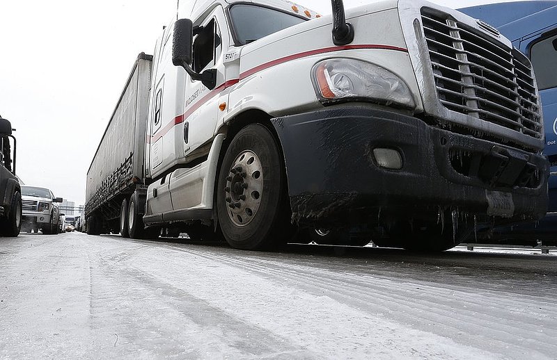 WINTER WEATHER ALHY103A.jpg :: The roadway is a sheet of ice as Traffic is at a standstill on Interstate 65 northbound as officials work to clear abandoned vehicles Wednesday January 29,  2014 in Pelham,  Ala.  (AP Photo/Hal Yeager)