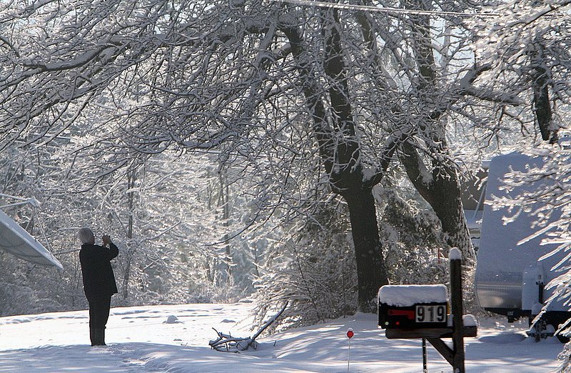 WINTER WEATHER ALHY103A2.jpg :: A person takes a picture of heavy snow and ice along Jeff Cook Parkway atop Lookout Mountain Thursday, Feb. 13,  2014 in Fort Payne Ala. A snow storm covered much of central and north Alabama Wednesday night with several inches of snow.  (AP Photo/Hal Yeager)