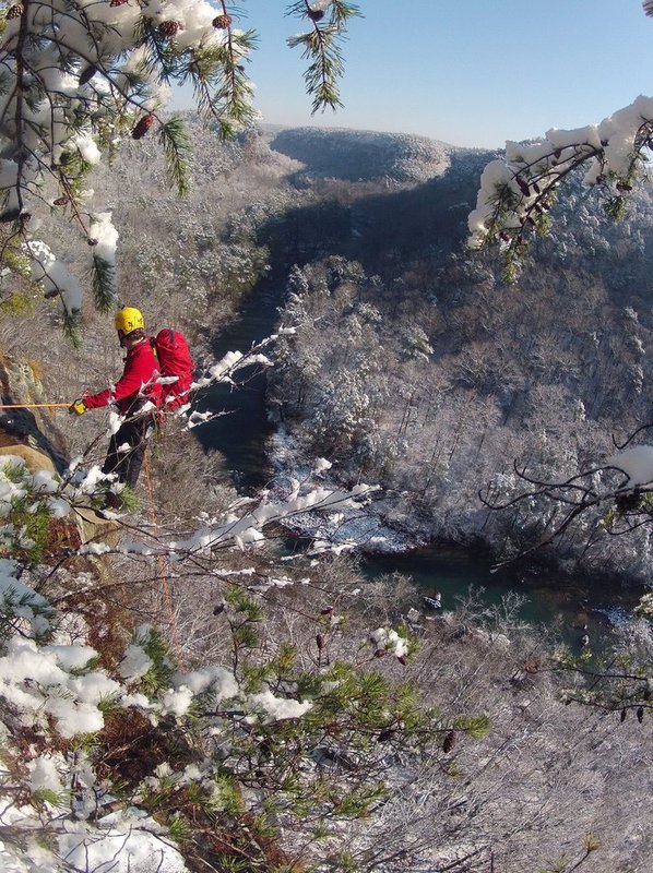 WINTER WEATHER ALHY106A.jpg :: Israel Partridge of True Adventure Sports prepare to rappel into a snow and ice covered Little River Canyon Thursday, Feb. 13,  2014 near Fort Payne Ala. A snow storm covered much of central and north Alabama Wednesday night with several inches of snow.  (AP Photo/Hal Yeager)