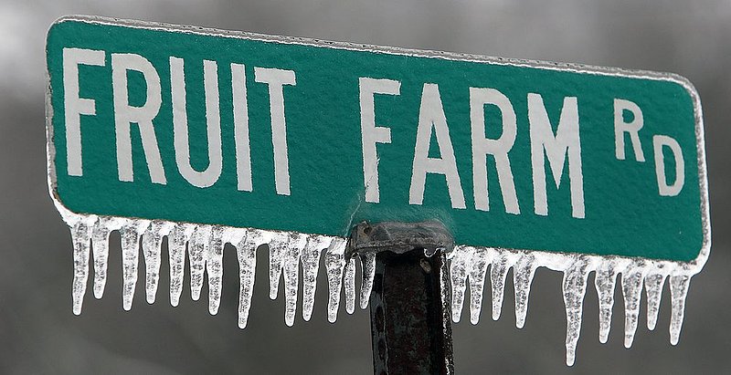 WINTER WEATHER ALHY107 9.53.42 PM1.jpg :: Ice hangs from a street sign in rural Dekalb county Wednesday Feb. 12,  2014 near Fort Payne Ala. Officials are warning of ice and snow accumulations as the day continues. (AP Photo/Hal Yeager)