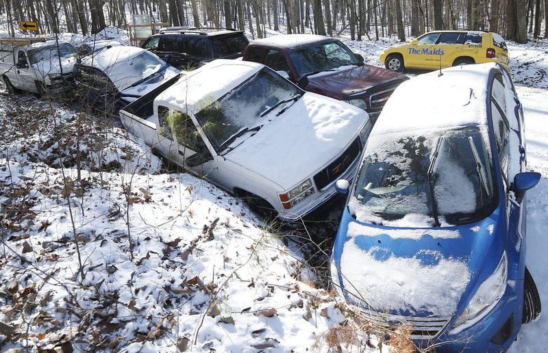 WINTER WEATHER ALHY108                             .jpg :: Cars lie staked together at the bottom of a hill on Grants Mill Road Thursday January 30,  2014 in Birmingham,  Ala.  The south woke up to more freezing temperatures but officials are hoping for a thaw and relief from the icy conditions. (AP Photo/Hal Yeager)