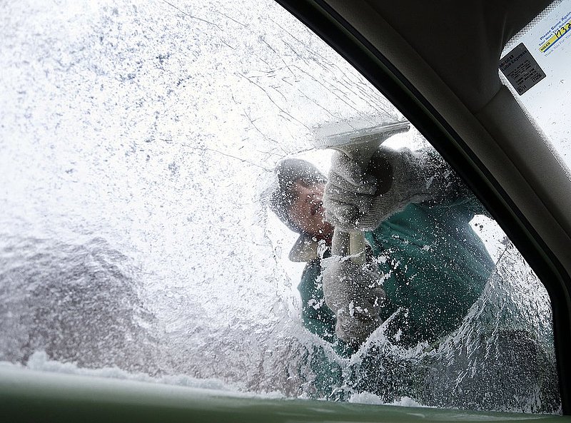 WINTER WEATHER ALHY108 9.53.42 PM.jpg :: Terry Gillis scrapes ice off of his car's side window Wednesday Feb. 12,  2014 in Fort Payne Ala. Officials are warning of ice and snow accumulations as the day continues. (AP Photo/Hal Yeager)