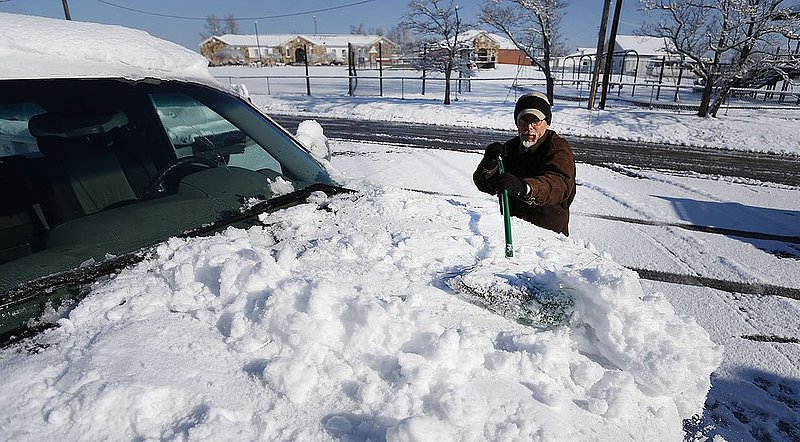 WINTER WEATHER ALHY108A.jpg :: Akins Furniture employee Russ Brozio sweeps snow off of a company truck Thursday, Feb. 13,  2014 in Dog Town,  Ala. A snow storm covered much of central and north Alabama Wednesday night with several inches of snow. ( (AP Photo/Hal Yeager)