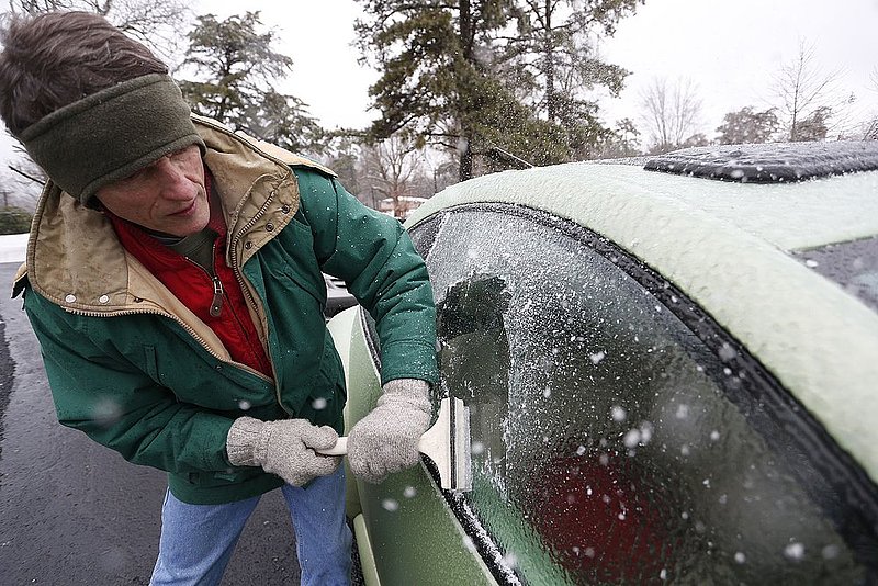 WINTER WEATHER ALHY109 9.53.42 PM.jpg :: Terry Gillis scrapes ice off of his driver side window Wednesday Feb. 12,  2014 in Fort Payne Ala. Officials are warning of ice and snow accumulations as the day continues.(AP Photo/Hal Yeager)