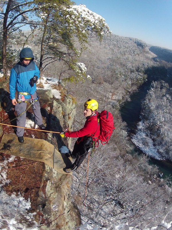 WINTER WEATHER ALHY111A.jpg :: Hobie McQuade assists Israel Partridge of True Adventure Sports prepare as he prepares to rappel into a snow and ice covered Little River Canyon Thursday, Feb. 13,  2014 near Fort Payne Ala. A snow storm covered much of central and north Alabama Wednesday night with several inches of snow.  (AP Photo/Hal Yeager)