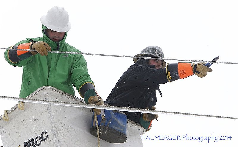 WINTER WEATHER ALHY114 16-54-57-139.jpg :: Fort Payne Improvement Authority workers Jonathan Henderson and Lance Woods work on lines that had become heavy with ice and were being blown around by high winds Wednesday Feb. 12,  2014 in Dog Town,  Ala. Officials are warning of ice and snow accumulations as the day continues. (AP Photo/Hal Yeager)