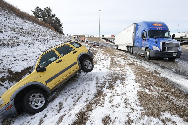 WINTER WEATHER ALHY116      .jpg :: A vehicle lies in the ditch where it was left during yesterday's snow storm. Officials worked to clear hundreds of abandoned vehicles Wednesday January 29,  2014 in Leeds,  Ala.  (AP Photo/Hal Yeager)