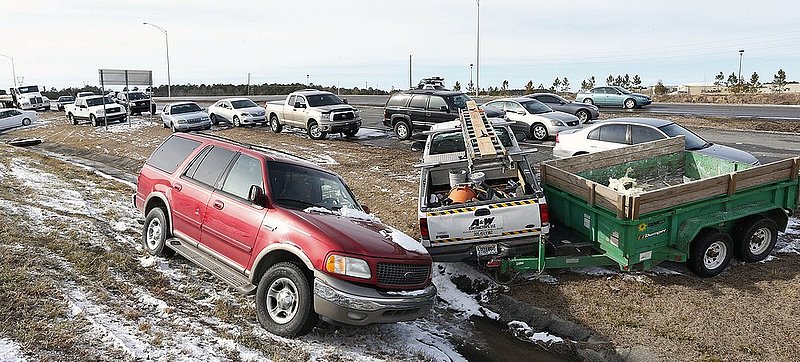 WINTER WEATHER ALHY117        .jpg :: Abandoned vehicles lay stacked together on US highway 78 Wednesday January 29,  2014 in Leeds,  Alabama. Officials work to clear abandoned vehicles and reopen numerous roads closed due to yesterday's snow storm.(AP Photo/Hal Yeager)