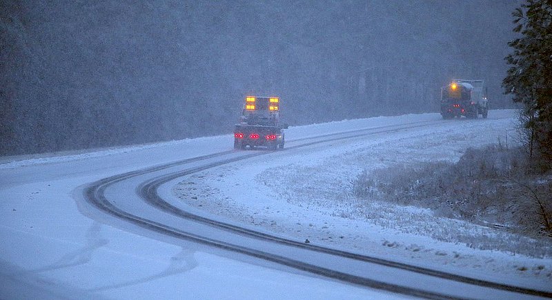 WINTER WEATHER ALHY117 9.53.43 PM.jpg :: A sand truck and an escort truck with the Fort Payne Public Works travel along highway 35 atop Lookout Mountain as heavy snow falls Wednesday Feb. 12,  2014 in Fort Payne Ala.  (AP Photo/Hal Yeager)