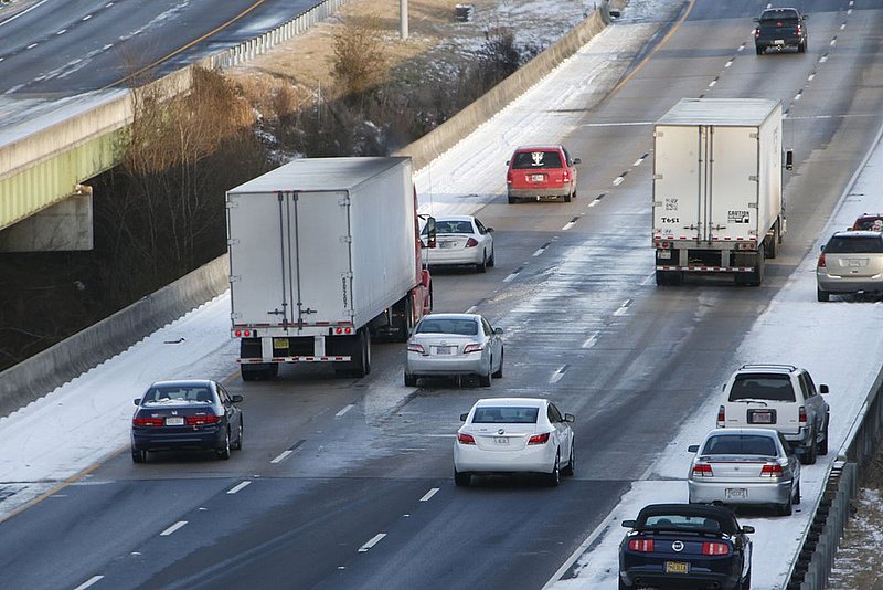 WINTER WEATHER ALHY125               .jpg :: Eastbound traffic maneuvers around an abandoned car, middle lane, on Interstate 20 Wednesday January 29,  2014 in Leeds,  Ala. The car was later struck from behind by a tractor-trailer completely totaling it. (AP Photo/Hal Yeager)