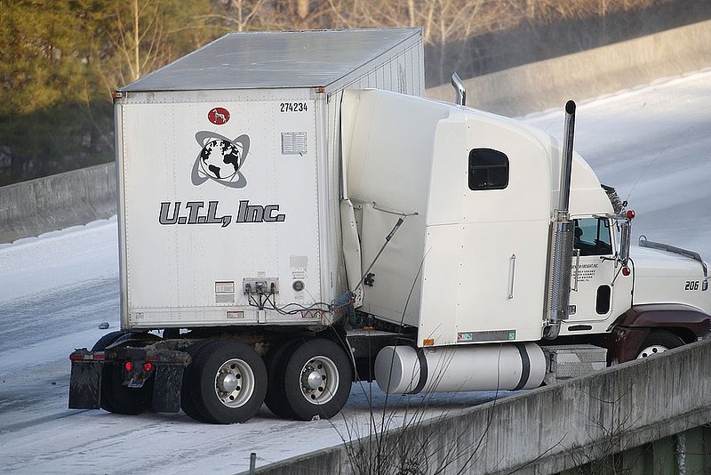 WINTER WEATHER ALHY127                 .jpg :: A tractor-trailer jack knifes on a bridge on Interstate 20 Wednesday January 29,  2014 in Leeds,  Ala.  As the sun went down, water again turned to ice making driving conditions dangerous. (AP Photo/Hal Yeager)