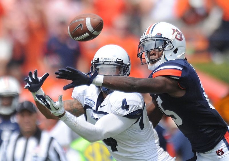 done COLOR 091103 UTAH STATE AUBURN.jpg :: Despite the efforsts of Auburn defensive back Neiko Thorpe (15) Utah State wide receiver Matt Austin (4) makes the catch at Jordan-Hare Stadium Saturday, September 3, 2011 in Auburn, Ala. (The Birmingham News, Hal Yeager)