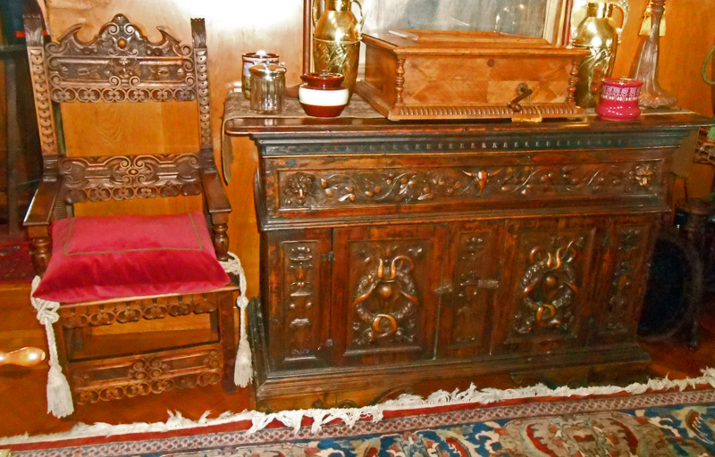 Throne Chair and Carved Blanket Chest.jpg :: A view of the Italian Renaissance chair with a cushion next to a carved blanket chest from the same era. 