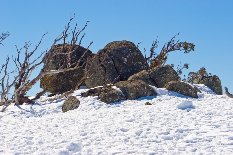 Australia 090.jpg :: Rocks stand out on the peak of a snowy mound in the Australian Snowy Mountains