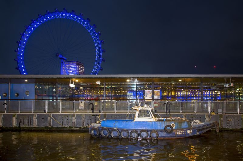Blue Boat in front of the London Eye - London.jpg