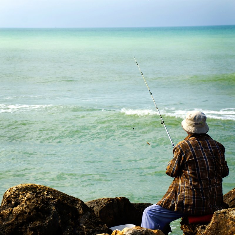 Fisherman.jpg :: Man fishing off rocks