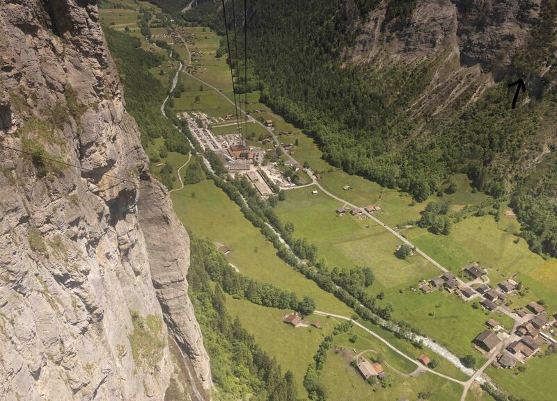 GQ7A8371 copy (1)(1).jpg :: During the cable car descent from Gemmelwald we did not realize a drama was unfolding on the far cliff indicated by the black arrow pointing to a small red spot.