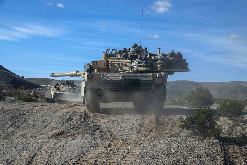 1st Armored Div - A177A.jpg :: 1st Armored Div, Post-Vietnam War - US ARMY PHOTO: U.S. Soldiers assigned to the 4th Battalion, 70th Armored Regiment, 1st Armored Brigade Combat Team, 1st Armored Division reposition to a fighting position during Rotation 24-04 at the National Training Center, Fort Irwin, Calif., 15 Feb 2024. (U.S. Army photo by Spc. Anastasiya Ludchenko Operations Group, National Training Center)