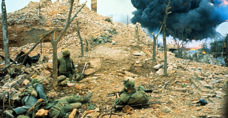 Tet Offensive - V27175D.jpg :: Battle of Hue, Tet Offensive, Vietnam War - US ARMY PHOTO: U.S. Forces are posted at the outer wall of a citadel in the ancient city of Hue, the scene of the fiercest fighting of the Tet Offensive. In the distance soldiers watch a bomb exploding in a moat.