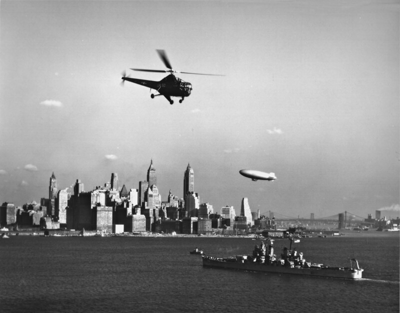 USS Columbus (CA-74) - N1923E.jpg :: USS Columbus (CA-74), Heavy Cruiser, Korean War - US NAVY PHOTO: A US Navy HO3S-1 helicopter assigned to HU-2 and a US Navy blimp are brought together with USS Columbus (CA-74) off NYC, 28 Mar 1951. 