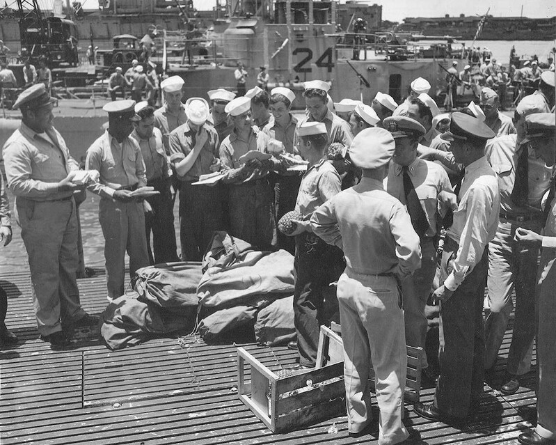 USS Kingfish (SS-234) - N9377J.jpg :: USS Kingfish (SS-234), Submarine, WW II - US NAVY PHOTO: Crewman aboard the USS Kingfish (SS-234) at Pearl Harbor, T. H. eagerly sort mail that has accumulated for them during absence on a war patrol, 15 May 1945.