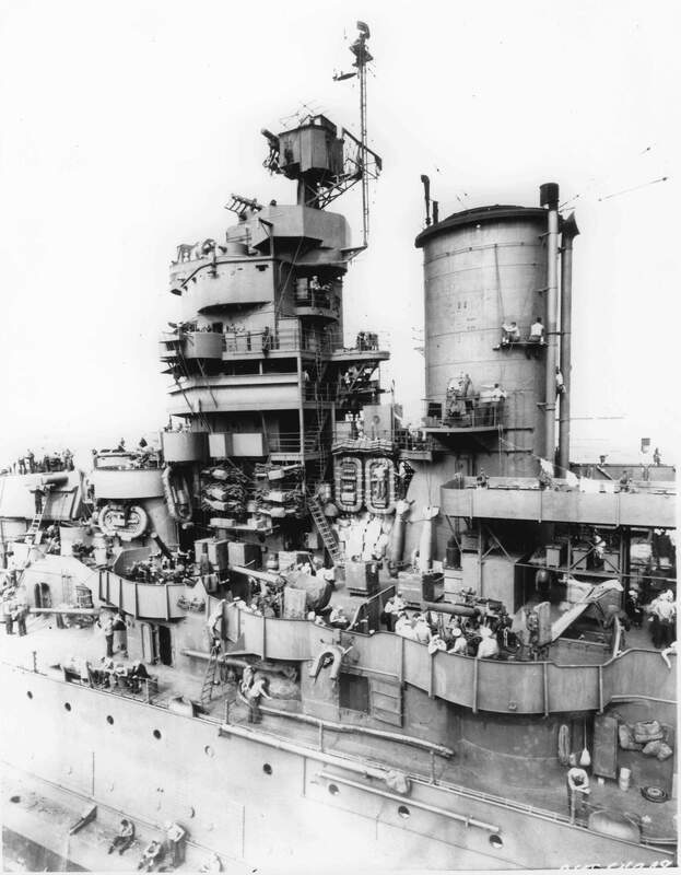 USS Mississippi (BB-41) - N38000C.jpg :: USS Mississippi (BB-41), Battleship, WW II - US NAVY PHOTO: Lots of action going on as sailors go through their work details aboard the USS Mississippi (BB-41) at San Francisco, CA. Oct 1943. Checking rations on the life rafts, hanging laundry, working on the funnel, etc. Note the new 20mm gallery P/S of the stack, on the mainmast radar platform an \