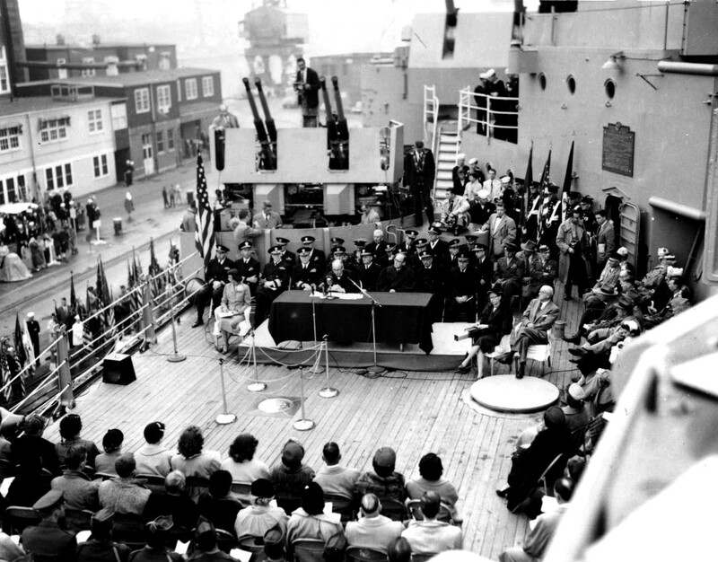 USS Missouri (BB-63)- N3010C.jpg :: USS Missouri (BB-63), Battleship, Post-Korean War - US NAVY PHOTO: USS Missouri (BB-63) docked at the Puget Sound Naval Shipyard, hosting the first Veterans Day holiday on the bridge. Observing the first federal court session of the naturalization ceremony with the immigrants to be naturalized, seated in the front rows on 8 Oct 1954. 